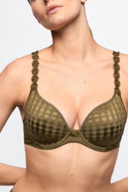 Woman wearing a green bra with floral details on a white background
